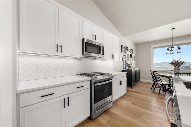 1616 S Morningside Heights Dr, Greenacres, WA 99016 - kitchen featuring appliances with stainless steel finishes, lofted ceiling, decorative backsplash, a chandelier, and white cabinetry