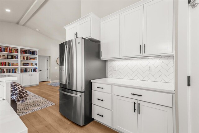 1616 S Morningside Heights Dr, Greenacres, WA 99016 - kitchen with stainless steel fridge with ice dispenser, vaulted ceiling, tasteful backsplash, white cabinetry, and light countertops