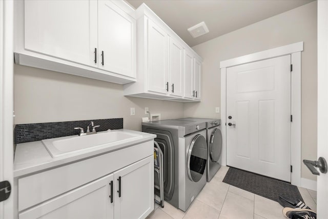 1616 S Morningside Heights Dr, Greenacres, WA 99016 - washroom with cabinet space, washing machine and dryer, and light tile patterned flooring
