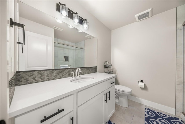 1616 S Morningside Heights Dr, Greenacres, WA 99016 - bathroom featuring toilet, vanity, tiled shower, tile patterned floors, and backsplash