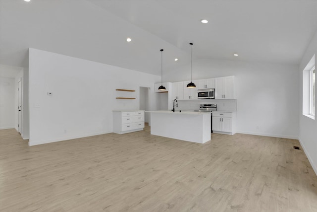 415 S Mckee St, Spokane Valley, WA 99016 - unfurnished living room with lofted ceiling, light wood-style floors, recessed lighting, baseboards, and a sink