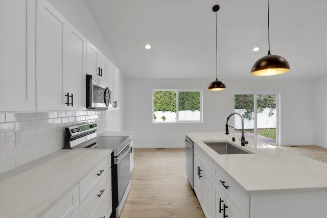 415 S Mckee St, Spokane Valley, WA 99016 - kitchen with appliances with stainless steel finishes, a sink, decorative backsplash, plenty of natural light, and recessed lighting