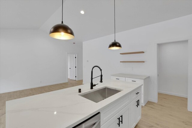 415 S Mckee St, Spokane Valley, WA 99016 - kitchen featuring a sink, light stone countertops, hanging light fixtures, white cabinetry, and light wood finished floors
