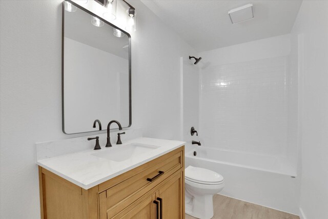 415 S Mckee St, Spokane Valley, WA 99016 - bathroom with vanity, wood finished floors, toilet, and tub / shower combination
