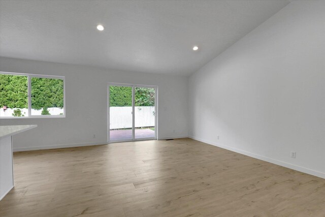 415 S Mckee St, Spokane Valley, WA 99016 - spare room featuring light wood-type flooring, recessed lighting, baseboards, and lofted ceiling
