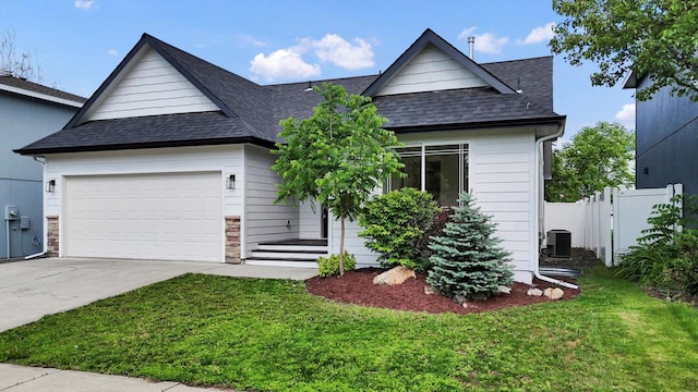 415 S Mckee St, Spokane Valley, WA 99016 - view of front facade with roof with shingles, concrete driveway, central air condition unit, and a garage