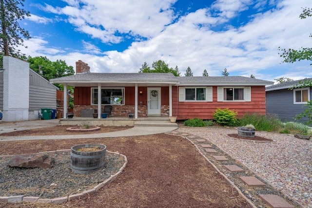 3225 E 16th Ave, Spokane, WA 99223 - ranch-style home with a fire pit, covered porch, a chimney, and cooling unit