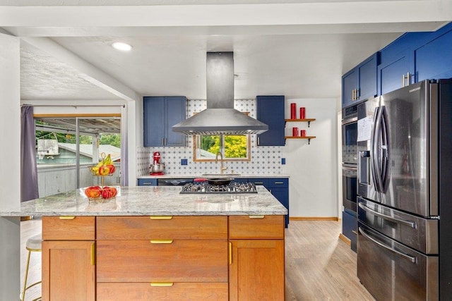 3225 E 16th Ave, Spokane, WA 99223 - kitchen featuring stainless steel appliances, island range hood, a sink, light wood-style floors, and decorative backsplash