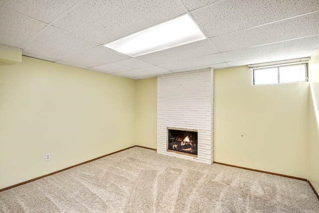 3225 E 16th Ave, Spokane, WA 99223 - below grade area with carpet flooring, a paneled ceiling, a large fireplace, and baseboards