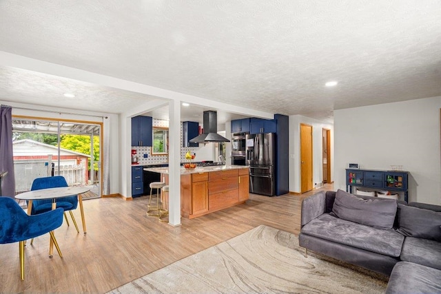 3225 E 16th Ave, Spokane, WA 99223 - living area featuring light wood-type flooring, a textured ceiling, and recessed lighting