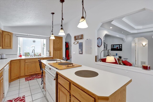 491 Eastshore Rd, Newport, WA 99156 - kitchen with white appliances, vaulted ceiling, a sink, light countertops, and arched walkways