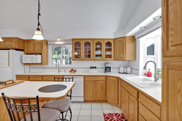 491 Eastshore Rd, Newport, WA 99156 - kitchen with white appliances, a sink, glass insert cabinets, light tile patterned floors, and light countertops