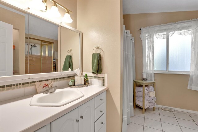 491 Eastshore Rd, Newport, WA 99156 - full bath featuring vanity, tile patterned flooring, baseboards, and curtained shower