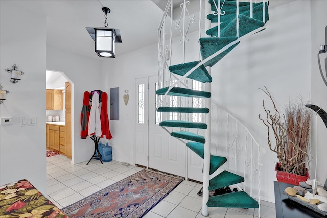 491 Eastshore Rd, Newport, WA 99156 - entrance foyer with stairway, light tile patterned floors, electric panel, and arched walkways