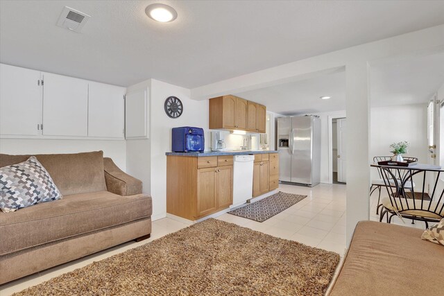 491 Eastshore Rd, Newport, WA 99156 - kitchen featuring stainless steel fridge, dishwasher, light tile patterned floors, light brown cabinetry, and recessed lighting
