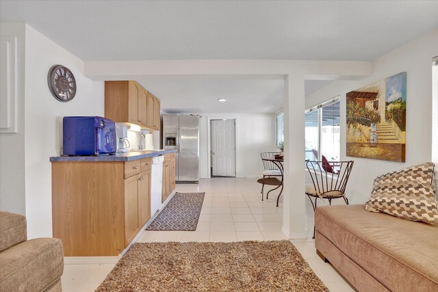 491 Eastshore Rd, Newport, WA 99156 - kitchen featuring stainless steel fridge with ice dispenser, white dishwasher, light tile patterned floors, light brown cabinetry, and a sink