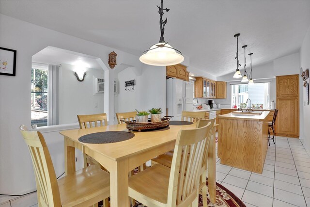 491 Eastshore Rd, Newport, WA 99156 - dining space with light tile patterned floors, healthy amount of natural light, and vaulted ceiling