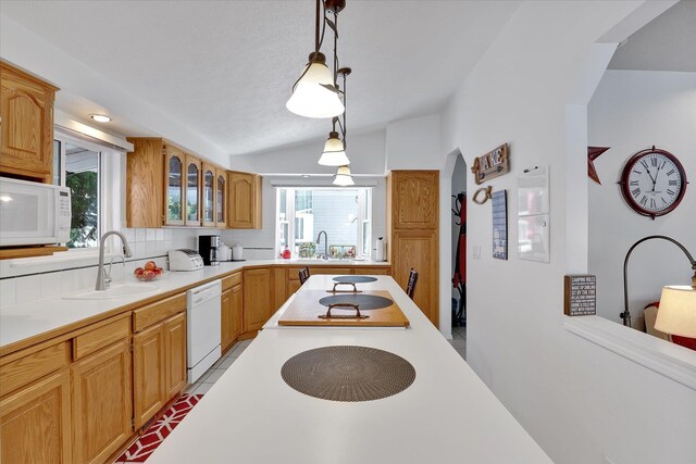 491 Eastshore Rd, Newport, WA 99156 - kitchen with white appliances, vaulted ceiling, a sink, light countertops, and glass insert cabinets