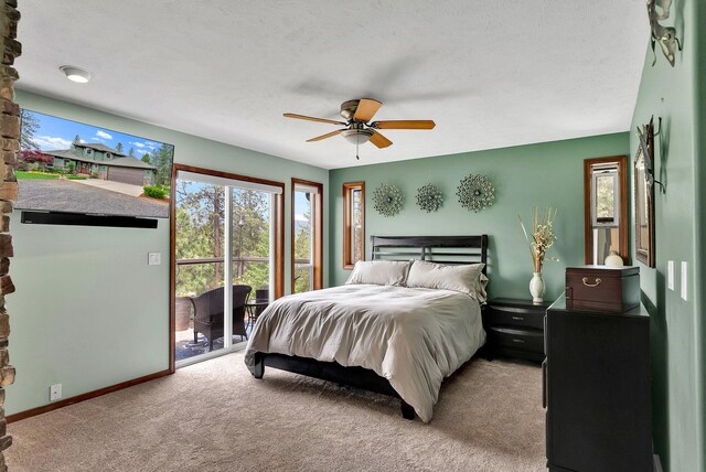 6533 D Lois Way, Nine Mile Falls, WA 99026 - bedroom featuring access to outside, light colored carpet, baseboards, and a ceiling fan