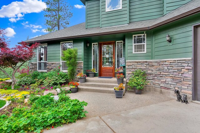 6533 D Lois Way, Nine Mile Falls, WA 99026 - doorway to property with stone siding and roof with shingles