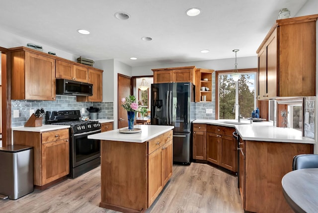 6533 D Lois Way, Nine Mile Falls, WA 99026 - kitchen with black appliances, open shelves, backsplash, light wood-style flooring, and a center island