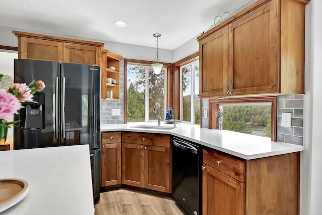 6533 D Lois Way, Nine Mile Falls, WA 99026 - kitchen with refrigerator with ice dispenser, dishwasher, a sink, light countertops, and tasteful backsplash
