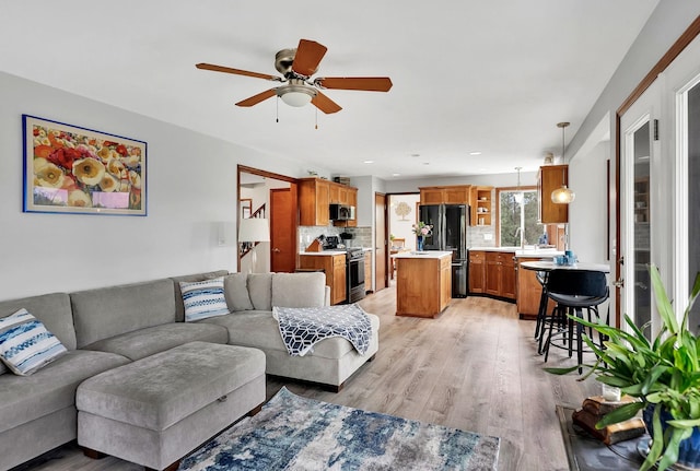 6533 D Lois Way, Nine Mile Falls, WA 99026 - living room featuring a ceiling fan and light wood finished floors