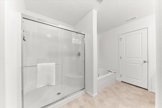 3105 N Rio Grande Rd, Spokane Valley, WA 99027 - bathroom featuring a shower stall, a garden tub, and a textured ceiling