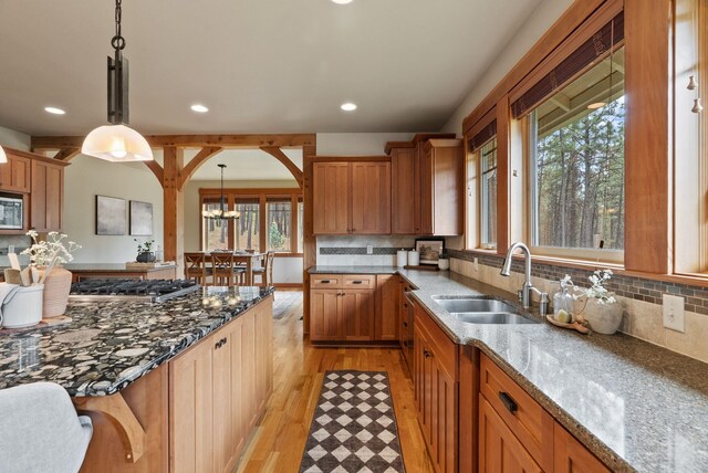1122 E Hangman Ln, Spokane, WA 99224 - kitchen featuring a sink, stainless steel appliances, light wood finished floors, dark stone countertops, and recessed lighting