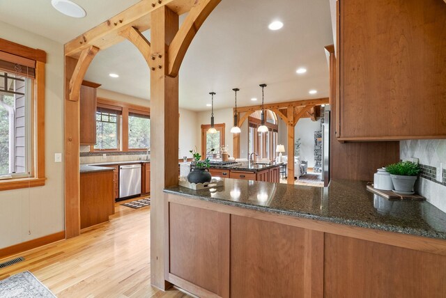 1122 E Hangman Ln, Spokane, WA 99224 - kitchen with dishwasher, arched walkways, recessed lighting, light wood-style floors, and a peninsula