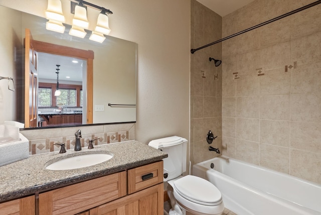 1122 E Hangman Ln, Spokane, WA 99224 - full bath featuring toilet, shower / bath combination, vanity, and decorative backsplash