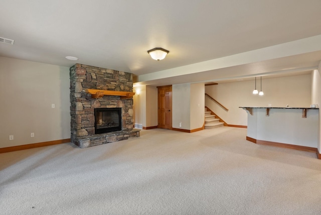 1122 E Hangman Ln, Spokane, WA 99224 - unfurnished living room featuring light carpet, baseboards, a fireplace, and stairs