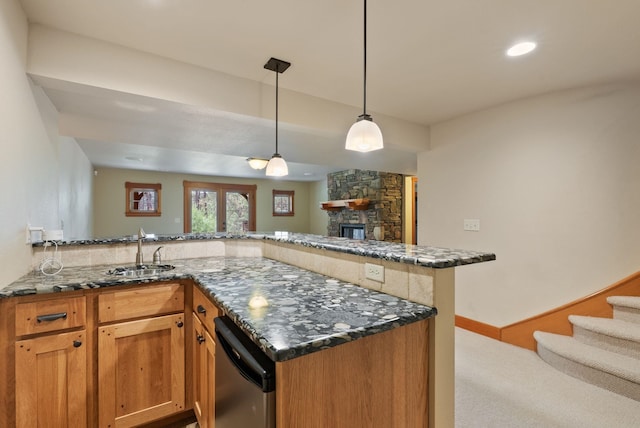 1122 E Hangman Ln, Spokane, WA 99224 - kitchen with a sink, dishwasher, dark stone countertops, a stone fireplace, and a peninsula