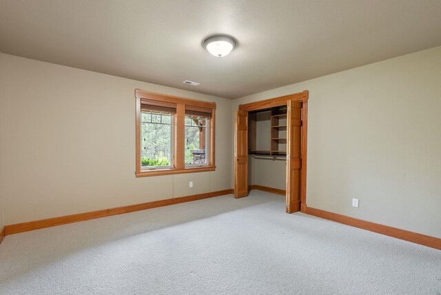 1122 E Hangman Ln, Spokane, WA 99224 - unfurnished bedroom featuring baseboards, light colored carpet, and a closet