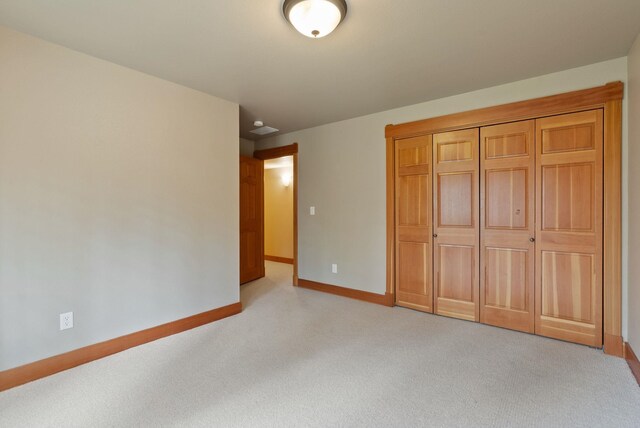 1122 E Hangman Ln, Spokane, WA 99224 - unfurnished bedroom featuring light colored carpet, baseboards, and a closet