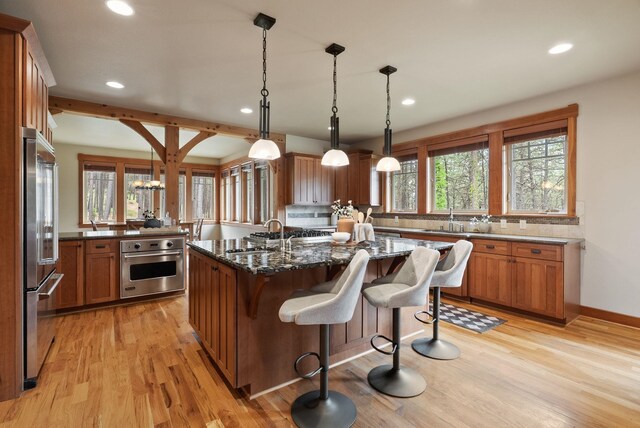 1122 E Hangman Ln, Spokane, WA 99224 - kitchen with appliances with stainless steel finishes, recessed lighting, a sink, a breakfast bar area, and backsplash