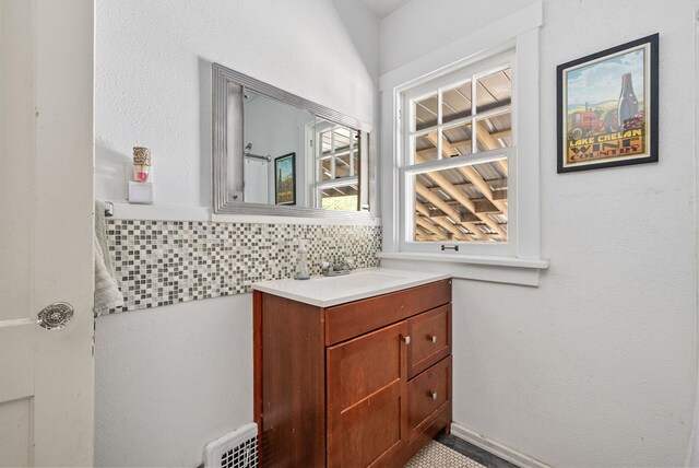 3507 E 28th Ave, Spokane, WA 99223 - bathroom with vanity, radiator, and tasteful backsplash
