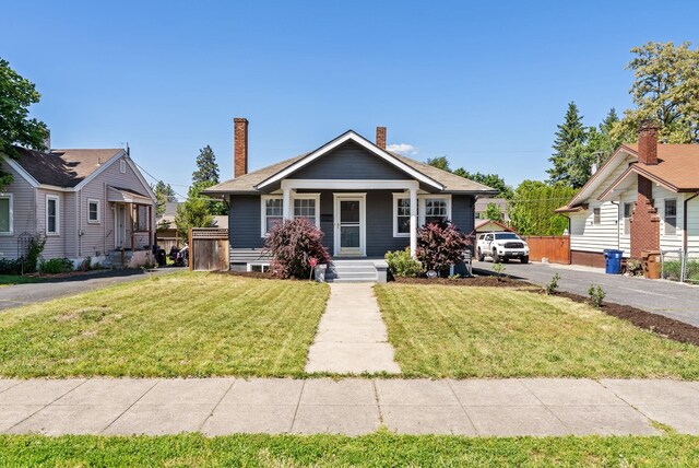 3507 E 28th Ave, Spokane, WA 99223 - bungalow-style home featuring covered porch, a front yard, and a chimney
