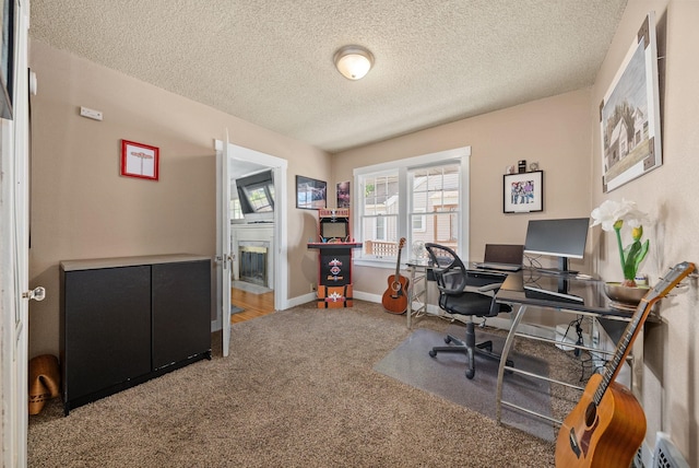 3507 E 28th Ave, Spokane, WA 99223 - carpeted office with a textured ceiling, baseboards, and a glass covered fireplace