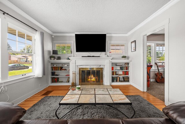 3507 E 28th Ave, Spokane, WA 99223 - living area with a textured ceiling, a fireplace, crown molding, wood finished floors, and baseboards