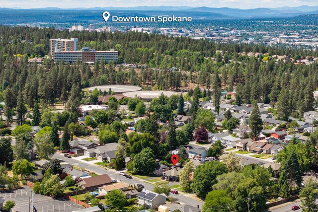 3507 E 28th Ave, Spokane, WA 99223 - drone / aerial view of a heavily wooded area and a mountain backdrop