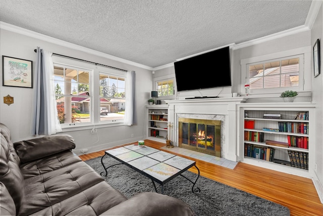 3507 E 28th Ave, Spokane, WA 99223 - living room featuring wood finished floors, ornamental molding, a textured ceiling, a high end fireplace, and baseboards
