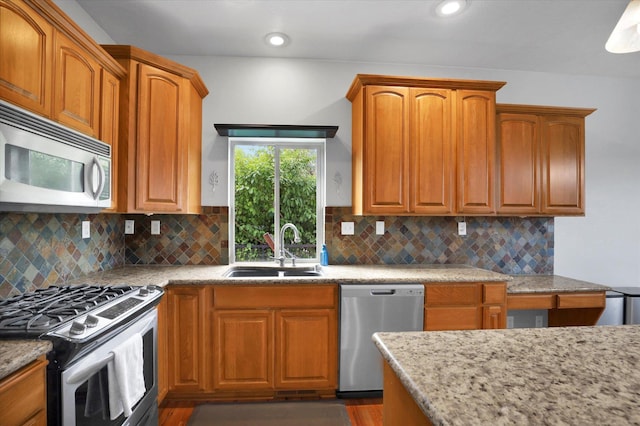 903 E Harding Ct, Spokane, WA 99218 - kitchen featuring stainless steel appliances, a sink, light stone countertops, decorative backsplash, and recessed lighting