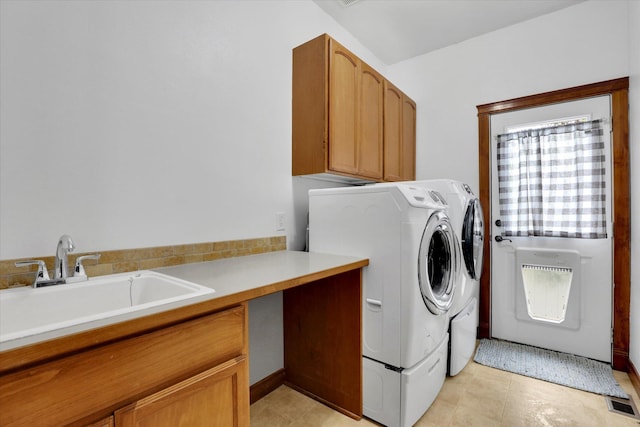 903 E Harding Ct, Spokane, WA 99218 - laundry room with washing machine and dryer, cabinet space, and light tile patterned floors