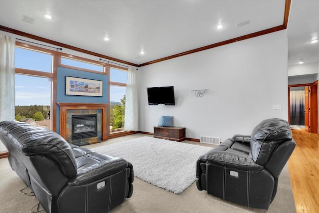 903 E Harding Ct, Spokane, WA 99218 - living area featuring crown molding, healthy amount of natural light, recessed lighting, a tiled fireplace, and wood finished floors