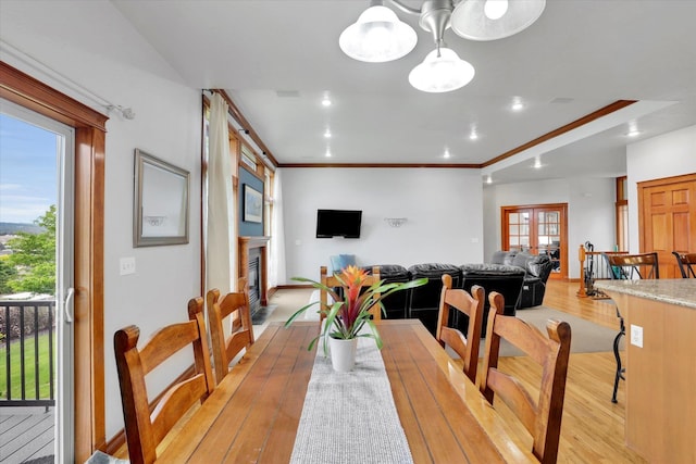 903 E Harding Ct, Spokane, WA 99218 - dining room featuring light wood-style floors, crown molding, recessed lighting, a glass covered fireplace, and baseboards