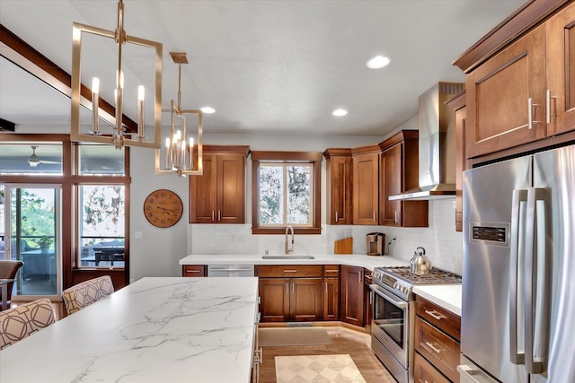4523 S Henrys Fork Ln, Spokane, WA 99206 - kitchen featuring appliances with stainless steel finishes, wall chimney exhaust hood, tasteful backsplash, brown cabinets, and recessed lighting