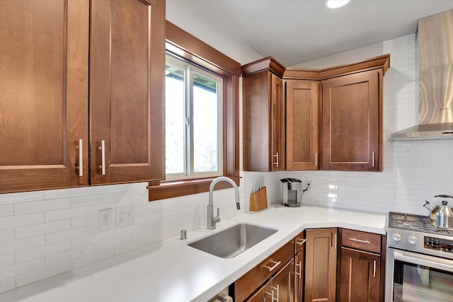 4523 S Henrys Fork Ln, Spokane, WA 99206 - kitchen with wall chimney range hood, stainless steel gas stove, decorative backsplash, and light countertops