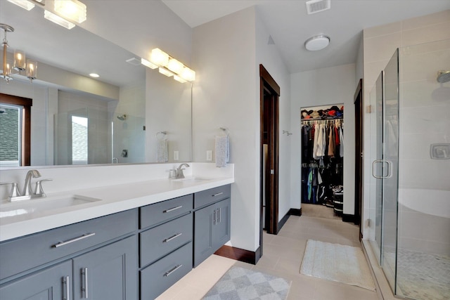 4523 S Henrys Fork Ln, Spokane, WA 99206 - full bathroom with double vanity, a stall shower, tile patterned floors, and a walk in closet