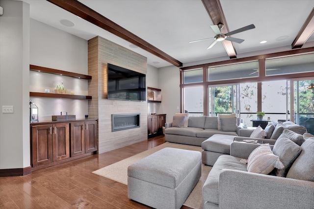 4523 S Henrys Fork Ln, Spokane, WA 99206 - living area with beam ceiling, light wood-style floors, a fireplace, and ceiling fan